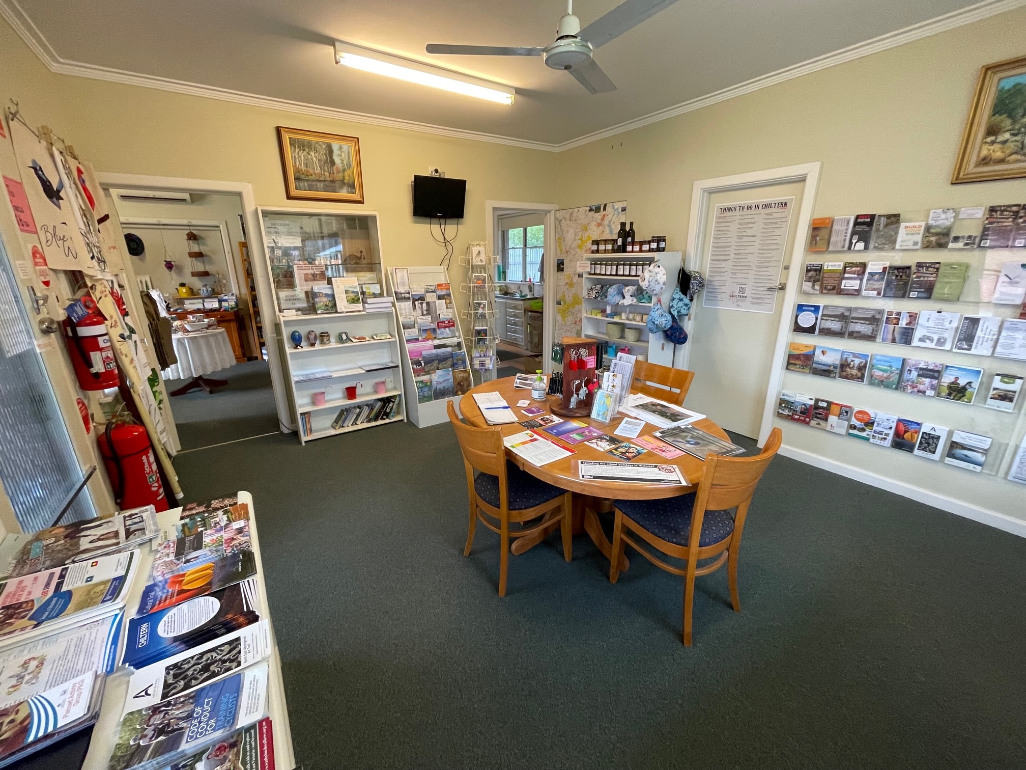 Main room of Chiltern info centre with large round table in the middle of the room and brochures on the wall.